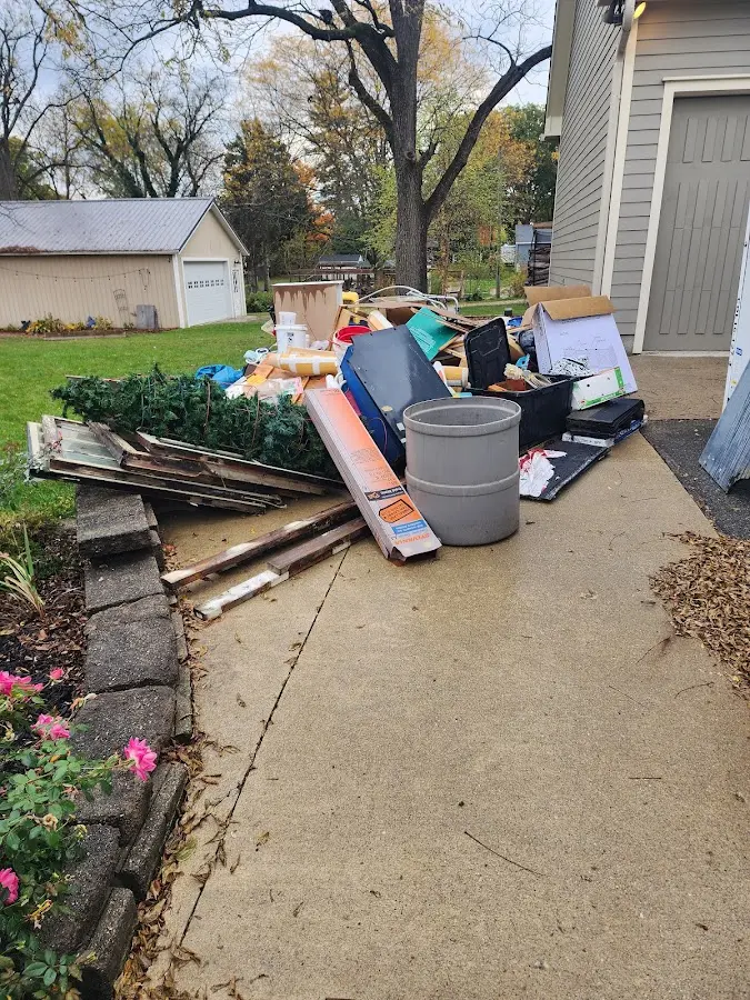 Dumpster being loaded with debris for Commercial Dumpster Rental in Durham